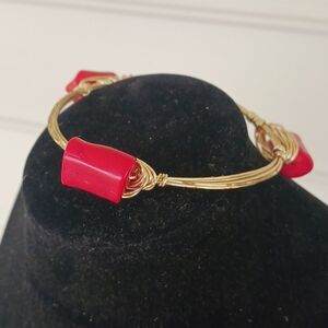 Goldtoned wire bangle bracelet with red stones